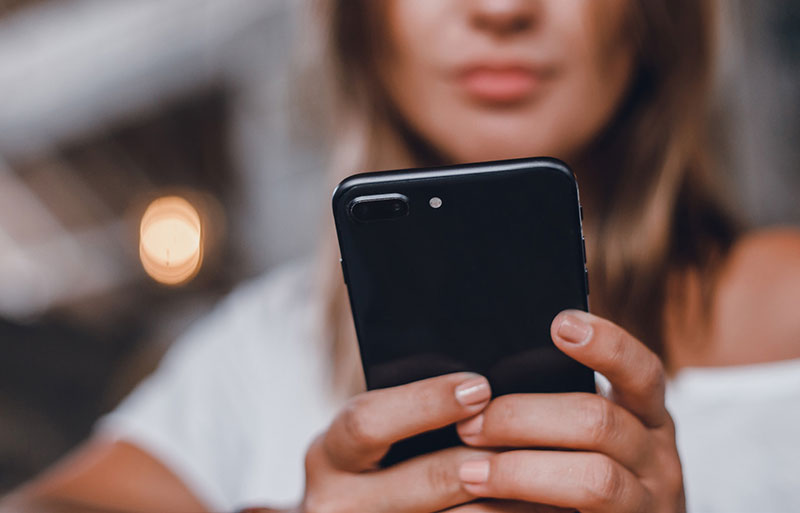 close up image of a person holding a phone